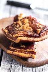 Whole smoked bacon on cutting board.