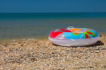 A bright inflatable ring on the seashore