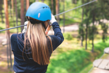 View of high ropes course, process of climbing in amusement acitivity rope park, passing obstacles...