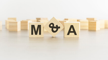 letters m and a on wooden blocks, white background