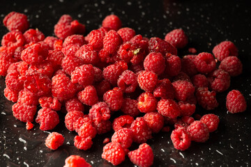 Fresh raspberries on dark background. Close up. Selective focus. useful product
