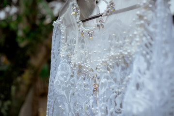 Naklejka na ściany i meble Detail wedding dress. Beautiful wedding dress decoration close up.