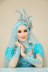 Beauty Fashion asian woman in hijab with Makeup and wearing blue wedding dress.