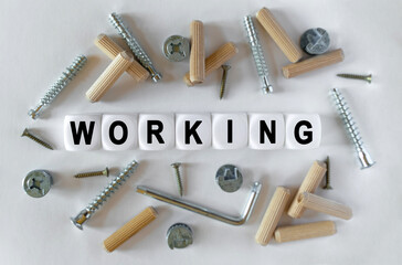 On a white background, building fittings and white cubes with the inscription - working