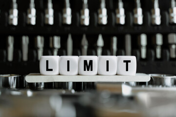 Against the background of a set of tools, white cubes with the inscription - limit