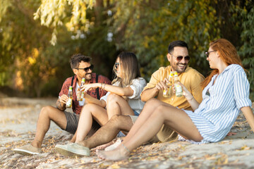 group of friends having fun on the beach