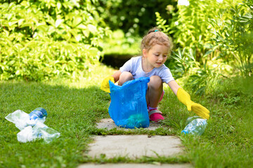Girl collection plastic garbage in nature. kid picking up trash in park. Earth Day April 22. Save...