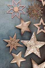 Frame border made of Christmas decorations, golden stars on vintage background.