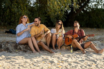 group of friends having fun on the beach