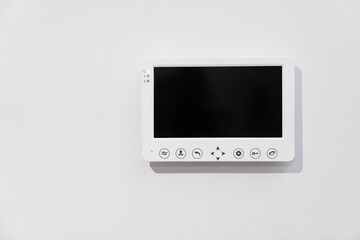 intercom screen on a white wall. home security and video surveillance.