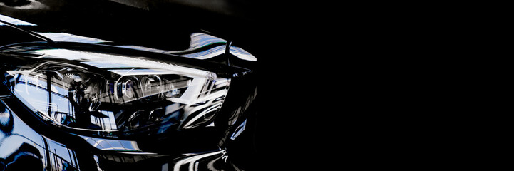banner. car headlight on a black background. dealer center.