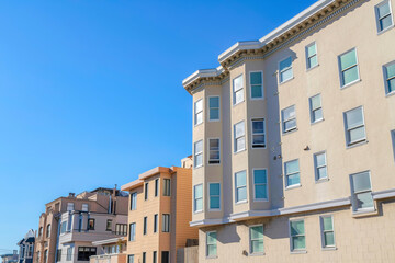 Fototapeta na wymiar Large residential buildings in a row in an urban area at San Francisco, CA