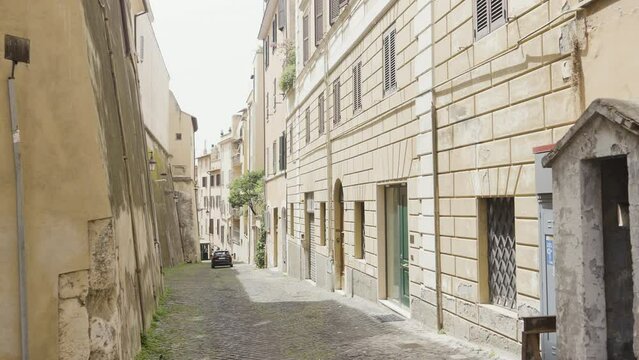 Cozy narrow street on a sunny day. Action. Italian beautiful empty street with a car.