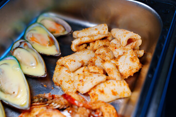 Chafing Dish with assorted grilled mussels and shrimps