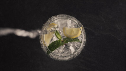 Sparkling lemon ice mint cocktail closeup. Making cocktail process concept