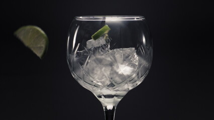 Lemons mint falls ice cubes wineglass closeup. 
