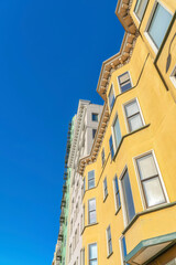 Low angle view of a residential building with yellow stucco wall in San Francisco, CA