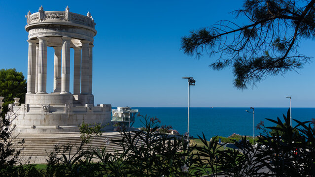 Monument to the Fallen ("Monumento ai Caduti") in front of the Passetto stairs in Ancona, Marche region in Italy, with a clear blue sea in the background on a sunny day