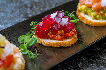 Bruschetta with salmon colored beetroot and cheese macro close up selective focus
