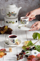 fruit tea with ripe blackberries, vintage still life with beautiful retro set 