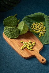 Fresh lotus seeds on a simple background
