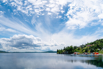 Interesting cloud formations roll in and partially cover the blue sky over Dildo Harbour, Newfoundland.