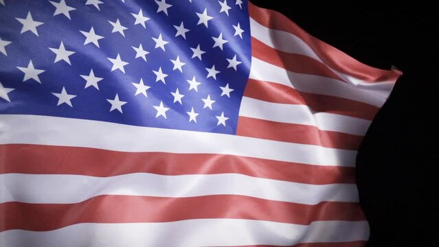 National Flag of the United States of America. It ripples in slow motion.
United States flag waving in slow motion. Black background.
