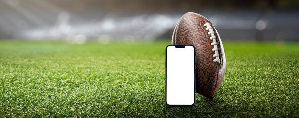 American football ball on the grass of a stadium - copyspace