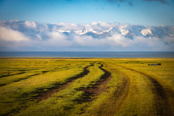 Obraz premium sunrise over the field, shore of song-köl lake, krygyzstan, central asia, mountains, high altitude