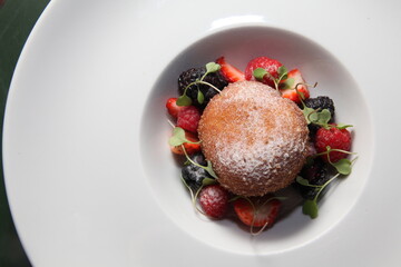 eclair dessert and red fruits top view close up