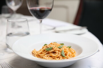Spaghetti and wine close up table view