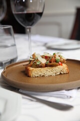 Italian bruschetta and wine glass on table top view