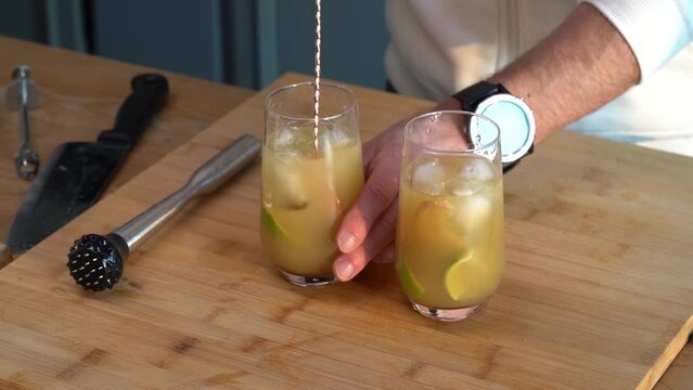 Bartender Mixing Alcoholic Drink With A Bar Spoon. - close up