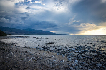shore of Issyk kul lake in Kyrgyzstan at sunset, Central Asia