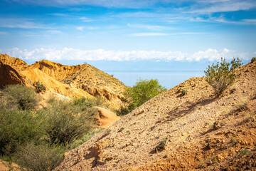 Fairytale canyon, Kyrgyzstan, Silk Road, Central Asia, red rocks, colourful, Yssykkul lake in background