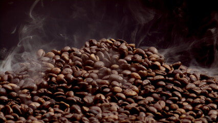 Steam rising coffee beans heap close up. View process roasting caffeine seeds.