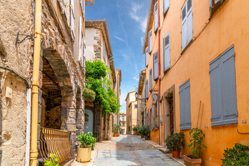 A charming, picturesque street in the medieval village of Grimaud, France, in the hills above Saint-Tropez along the French Riviera.