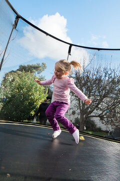 Cute litle girl having fun on trampoline