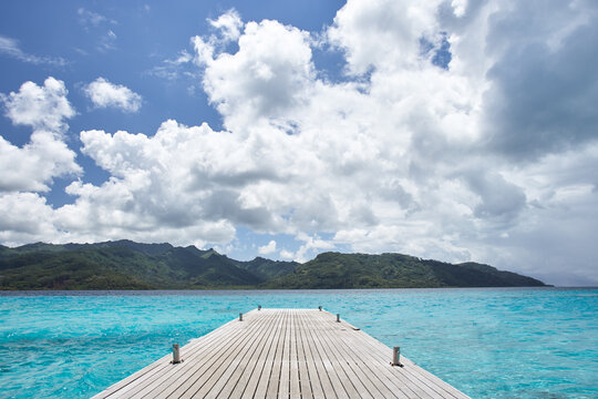 Wood boat dock off the island of Tahiti at luxury resort