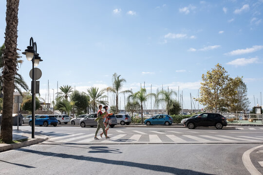 Sportswomen crossing road in city
