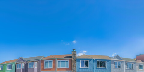 Fototapeta na wymiar Colorful adjacent suburban houses below the clear sky at San Francisco, California
