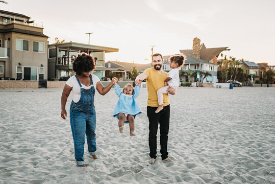 Family playing in the sand
