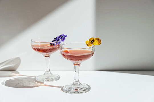 Juicy cocktail drinks with flowers and sunlight 