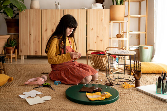 Girl Making Puppets At Home