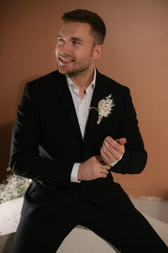 Sitting Groom In Black Suit