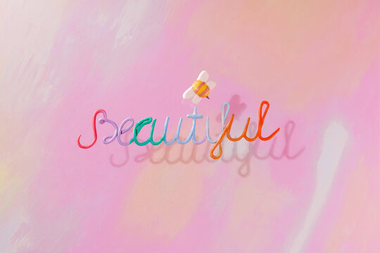 On a colorful background, the word "beautiful" and around it