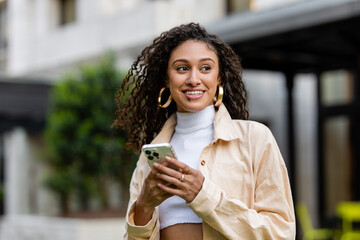Happy Woman Smiles While Holding Cell Phone