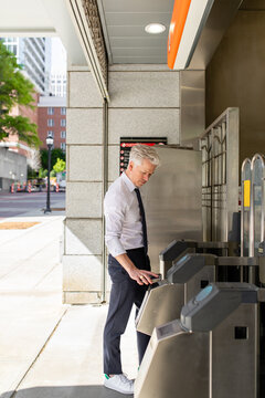 Man Uses Tap Card To Enter Public Transportation System