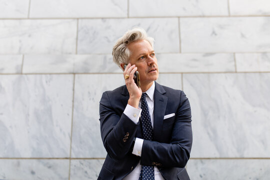 Professional Man Wearing A Suit Makes A Call While On His Break