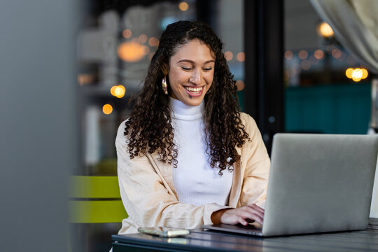 Young Woman Works On Computer At A Cafe 